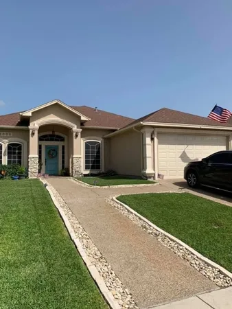 a front view of a house with a garden