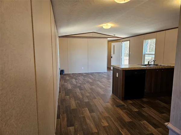 a view of room with window and wooden floor