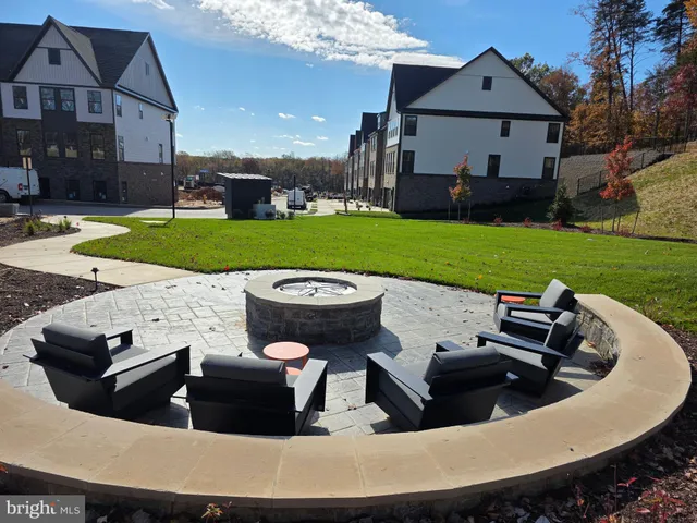 a view of a house with backyard sitting area and swimming pool