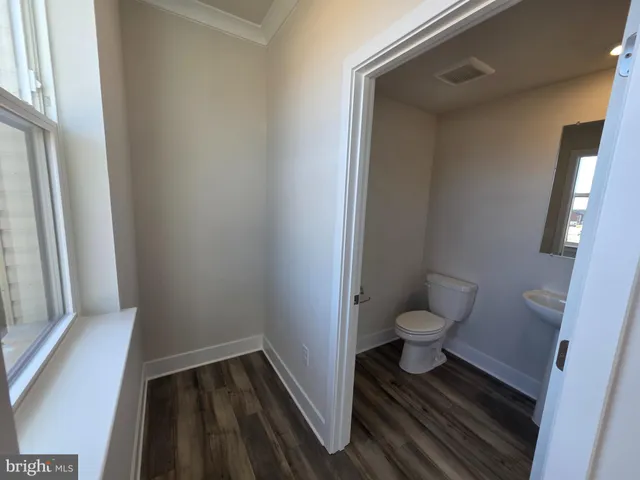 a bathroom with a toilet and a window