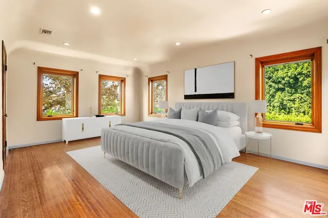 a bedroom with a large bed and a window