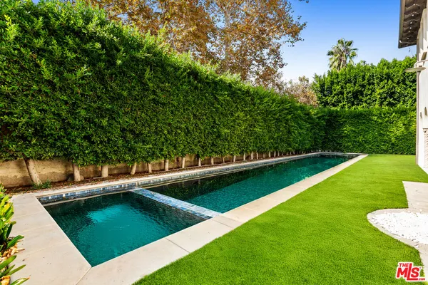 a view of a swimming pool with a yard