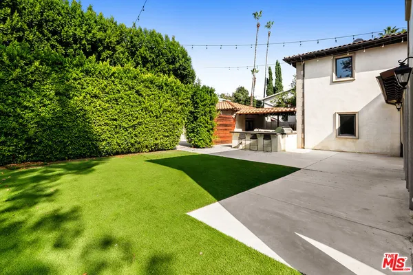 a view of a backyard with sitting area