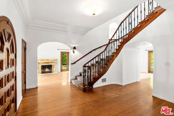 a view of entryway and hall with wooden floor