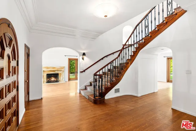 a view of entryway and hall with wooden floor