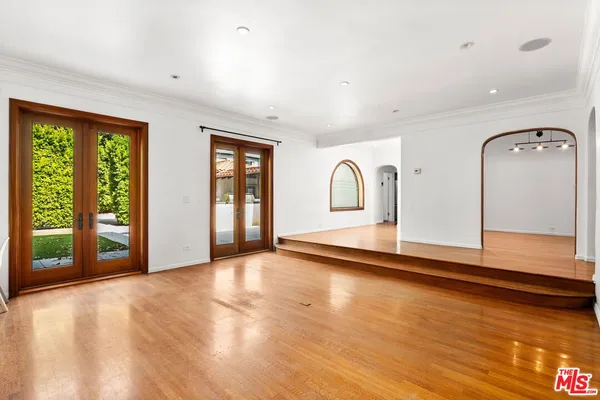 a view of a livingroom with wooden floor and a large window