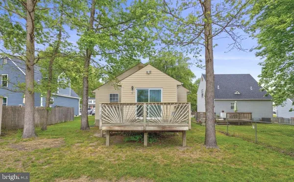 a front view of a house with garden and deck