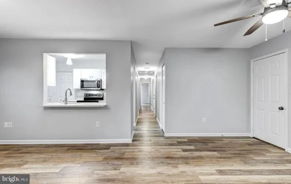 a view of a livingroom with wooden floor and a window