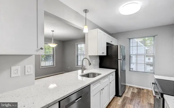 a kitchen with a sink a stove and refrigerator