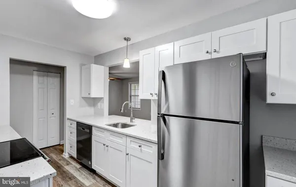 a kitchen with stainless steel appliances a refrigerator sink and cabinets