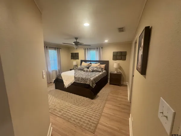 a spacious bedroom with a bed a couch and a dresser