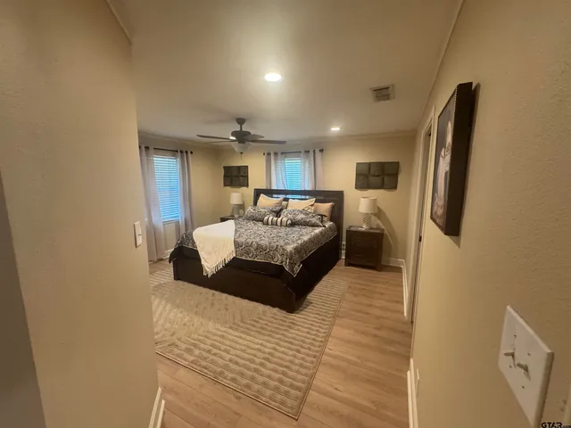 a spacious bedroom with a bed a couch and a dresser