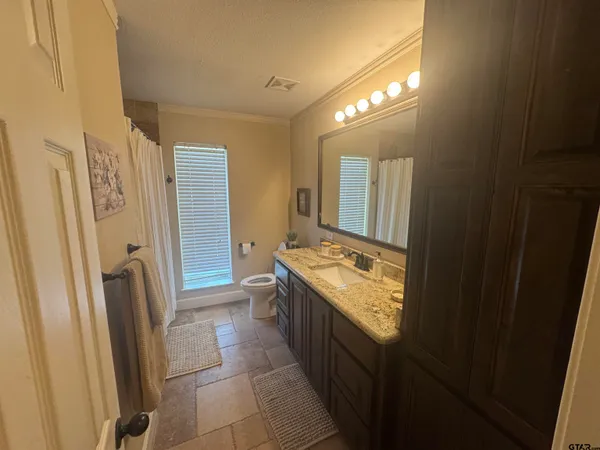 a bathroom with double vanity and a mirror