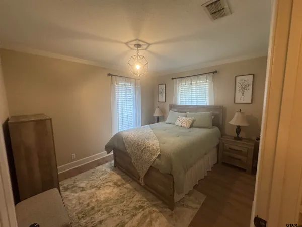 a bedroom with a bed and a mirror
