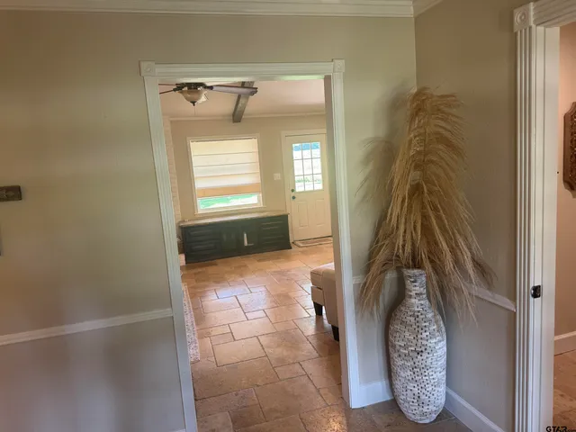 a walk in closet with wooden floor