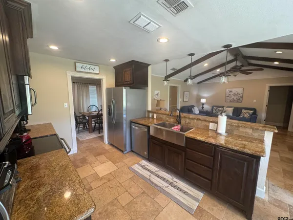 a large kitchen with lots of counter space and a sink