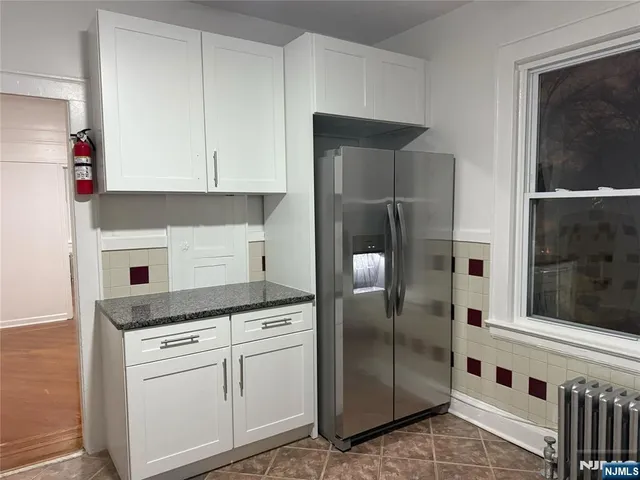 a kitchen with granite countertop a stove and a refrigerator