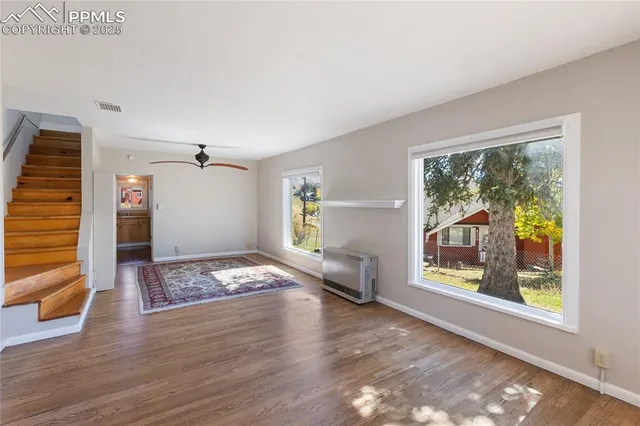 a view of workspace with window and wooden floor