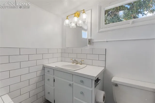 a bathroom with a sink a vanity and a mirror