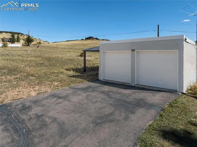 a view of a dirt road and a building