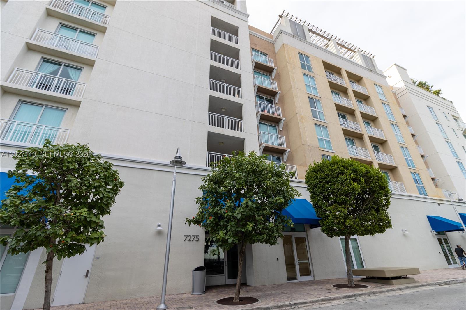 7275 Southwest 90th Way, Unit 213 Miami, FL 33156 - Photo 1 of 31 a front view of a building with street