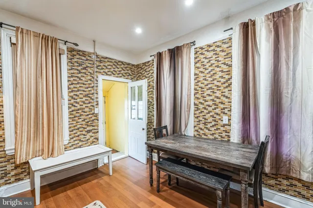 a view of a livingroom with wooden floor and a fireplace