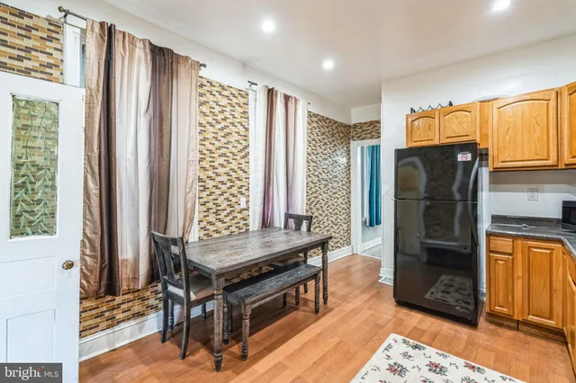 a kitchen with stainless steel appliances granite countertop a refrigerator a stove and a sink