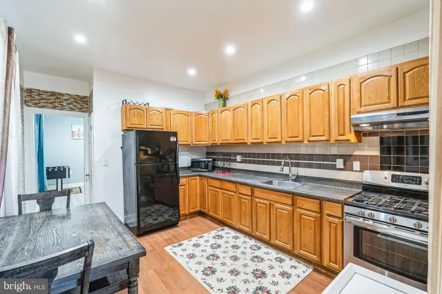 a view of a kitchen with granite countertop a microwave and a sink