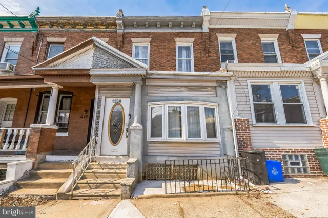 a front view of a house with many windows