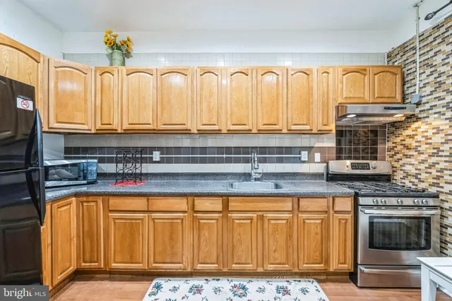 a spacious bathroom with a granite countertop sink and a mirror