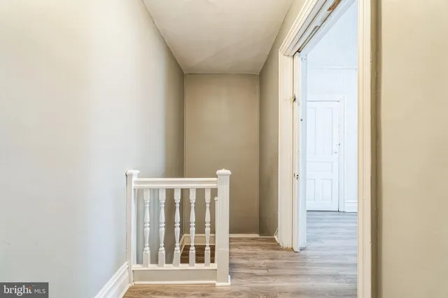 a view of a hallway with wooden floor