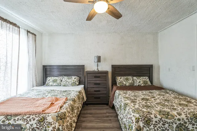 a bedroom with two beds and a window