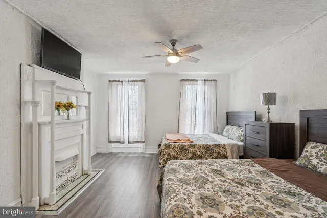 a bedroom with a large bed and a chandelier