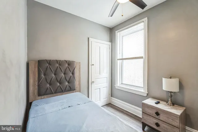 a view of hallway with bathroom and wooden floor