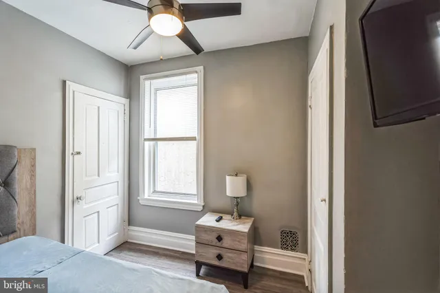 a view of a hallway with wooden floor and entryway