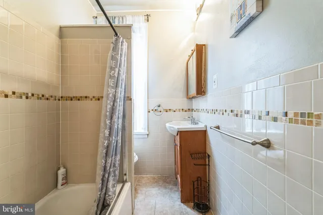 a bathroom with a shower sink and mirror