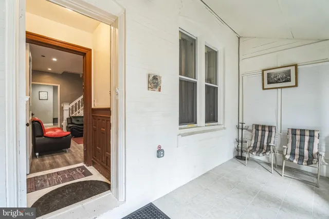 a view of front door with yard and furniture