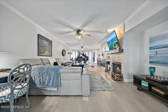 a living room with furniture a fireplace and a flat screen tv