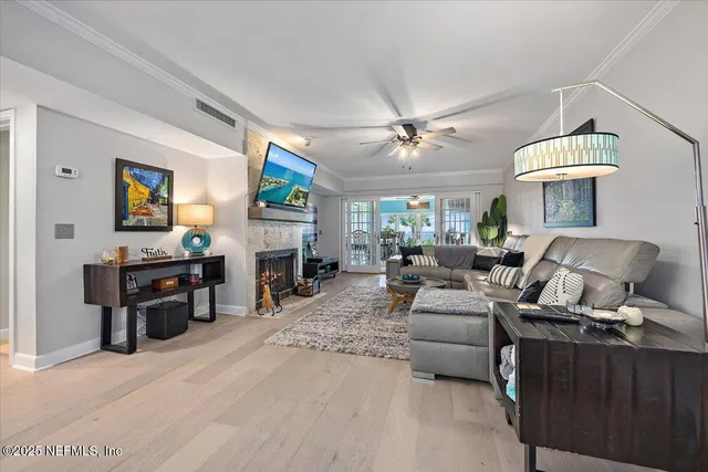 a living room with furniture a fireplace and a flat screen tv