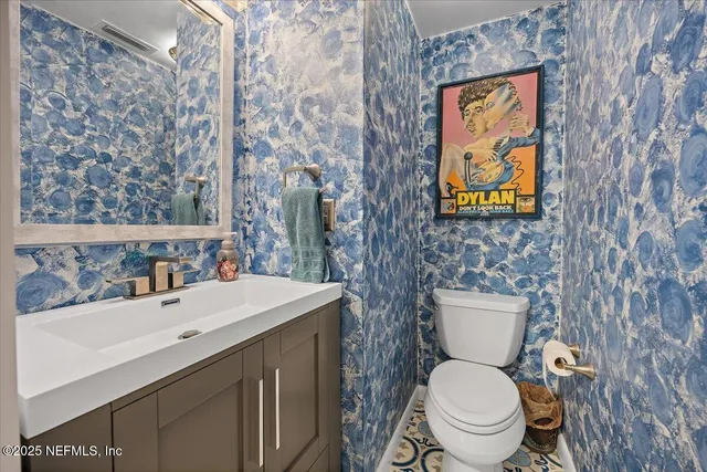a bathroom with a toilet sink and mirror