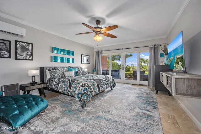 a spacious bedroom with a bed a couch and a flat tv screen on dresser