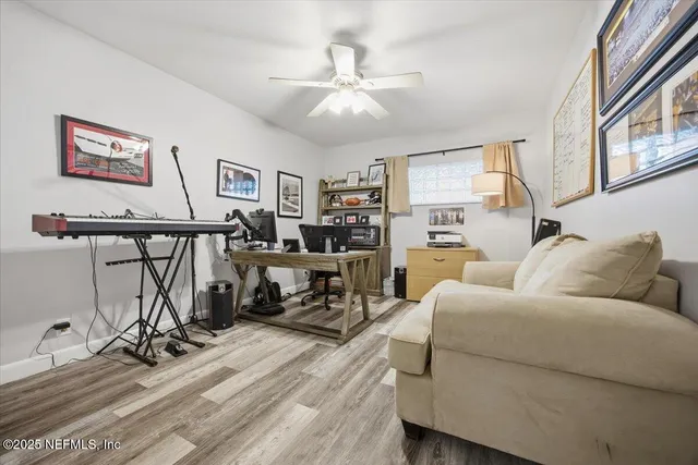 a living room with furniture a wooden floor and chandelier