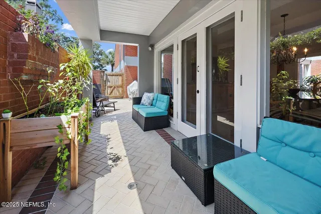 a balcony with furniture and a potted plant
