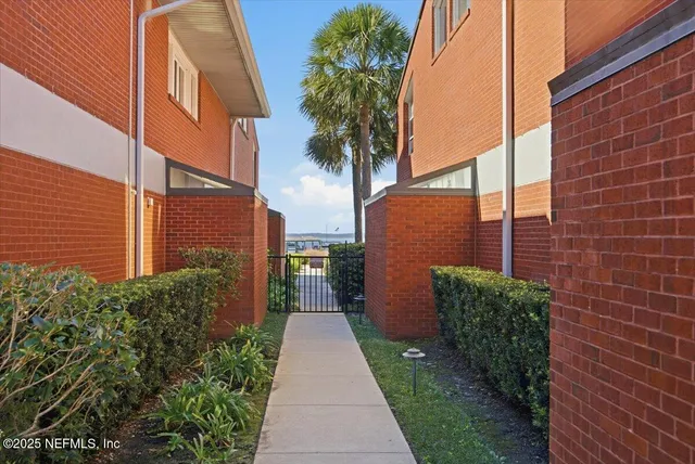 a pathway of a house with a yard