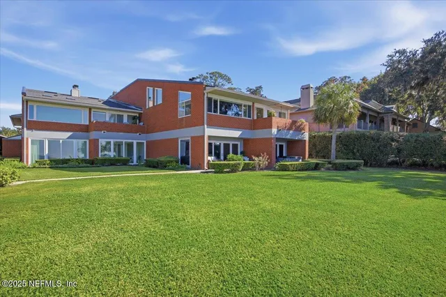 a front view of a building with a garden