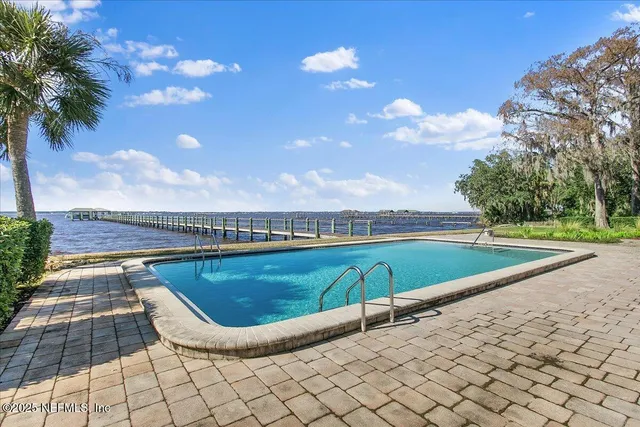 a view of a swimming pool with a lounge chair