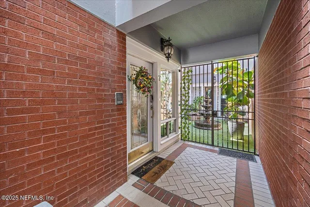 a view of a brick house with a large window