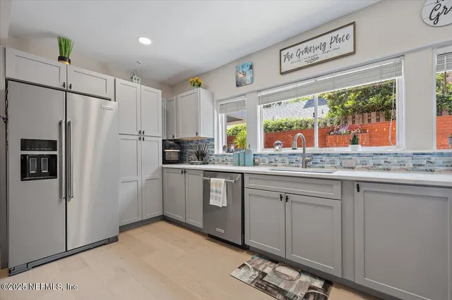 a kitchen with granite countertop a refrigerator and a sink