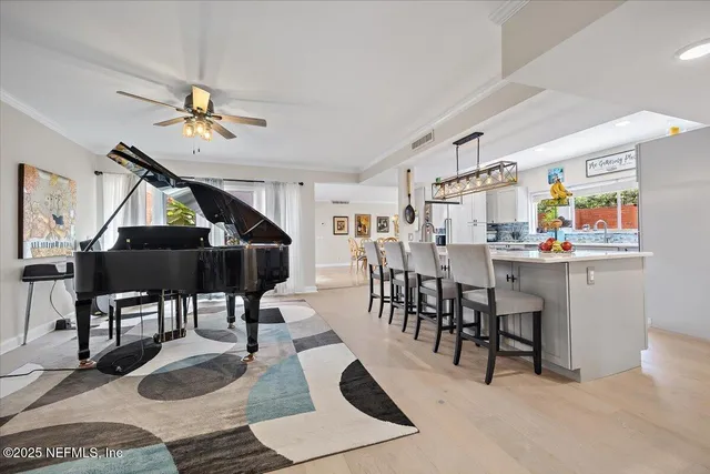 a living room with furniture a dining table and chairs