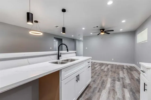 a kitchen with a sink and cabinets